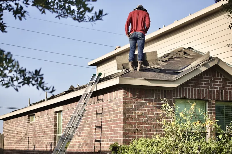 Professional roofer working on a residential roof in Ballentine Manor